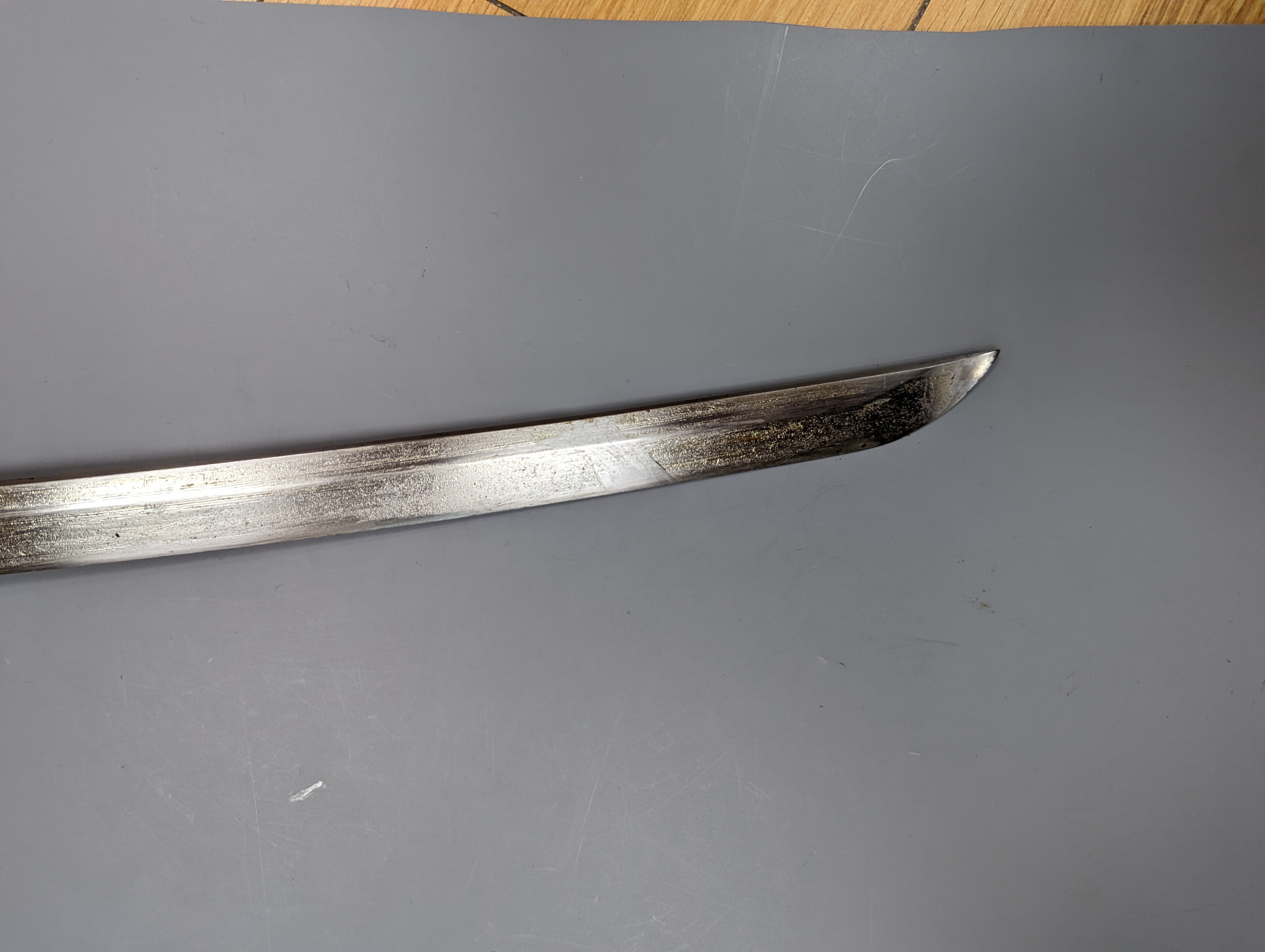 A Japanese Katana with leather covered sheath, plaque reading ‘Presented to Capt. S. Mear Telecoms B.M.A’ 93 cms long.